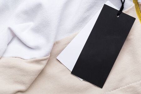 Clothing tag, label blank mockup on a clothes, to place your design.  fashion, people and shopping...