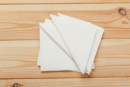 white paper napkin or tissue on the wooden table background.