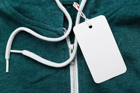 Clothing tag, label blank mockup on a clothes, to place your design.  fashion, people and shopping...