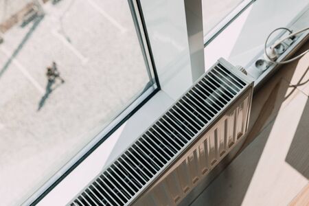 modern white radiator battery in the office near the window.