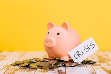 pink piggy bank on a yellow background, space for text. Finance, saving money, crisis. Business or Retirement Savingsの写真素材