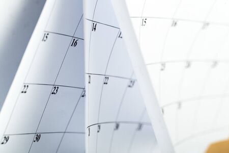 Closes a calendar page in blue. flipping calendarの写真素材