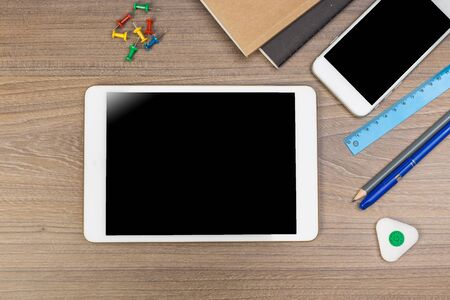 White digital tablet on wooden table. Flat lay.の写真素材