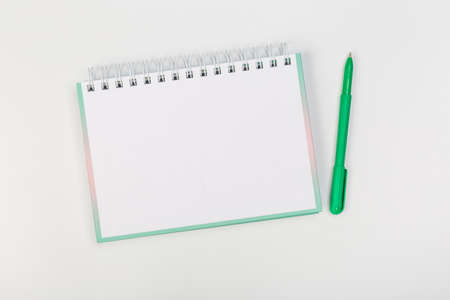 school notebook with pen isolated on white backgroundの写真素材