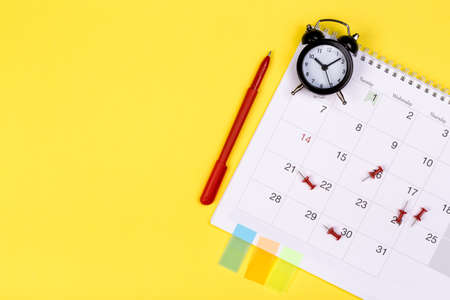 White clean calendar on solid yellow background with copy space, business meeting schedule, travel...