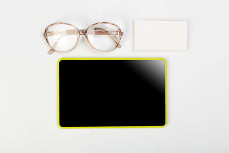 Tablet mockup and stationery on a white table with open space for text. Flat lay.の写真素材