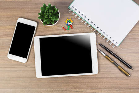 White digital tablet on wooden table. Flat lay.