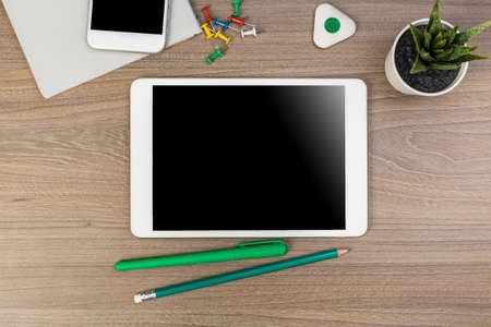 White digital tablet on wooden table. Flat lay.の写真素材