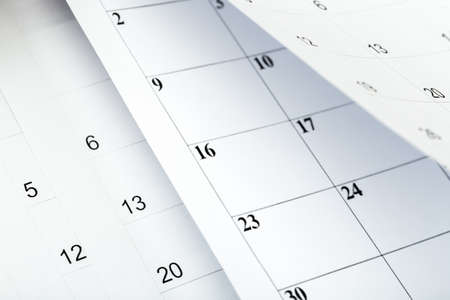 Closes a calendar page in blue. flipping calendar 2020の写真素材