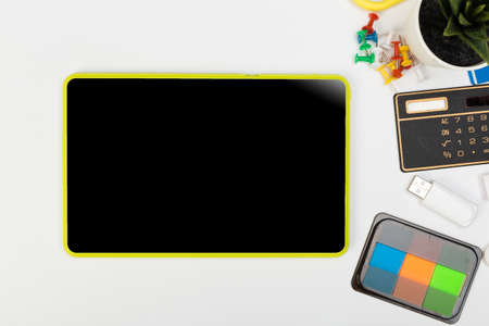 Tablet mockup and stationery on a white table with open space for text. Flat lay.の写真素材