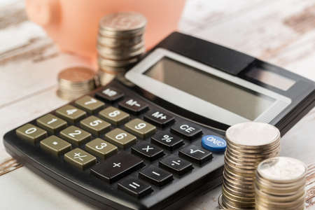 Coin money and banknote bills with a calculator. savings, finance, economics