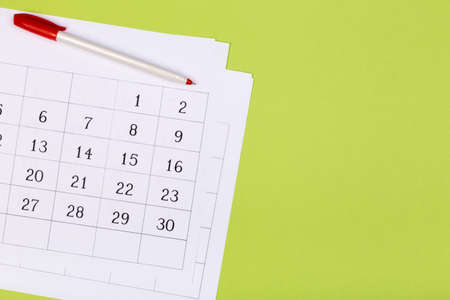 Open calendar on the table with green background, planning a business meeting or travel planning conceptの写真素材