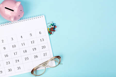 close up top view on white calendar 2020 month schedule to make appointment meeting or manage timetable each day lay on blue background for planning work and life conceptの写真素材