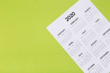 Open calendar on the table with green background, planning a business meeting or travel planning...