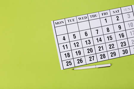 Open calendar on the table with green background, planning a business meeting or travel planning conceptの写真素材