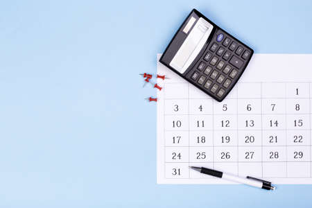 close up top view on white calendar 2020 month schedule to make appointment meeting or manage timetable each day lay on blue background for planning work and life conceptの写真素材