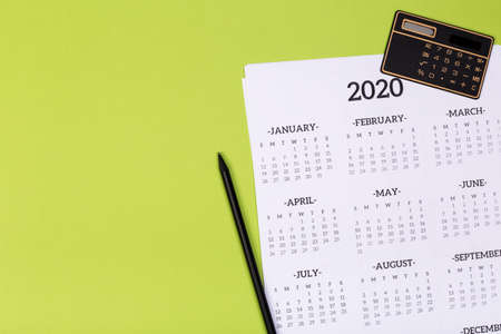 Open calendar on the table with green background, planning a business meeting or travel planning conceptの写真素材