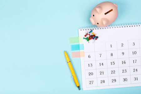 close up top view on white calendar 2020 month schedule to make appointment meeting or manage timetable each day lay on blue background for planning work and life conceptの写真素材