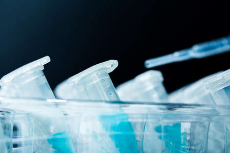 pipette and scientific laboratory test tubes in a genetic laboratory. study of a virus or...