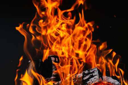 burning firewood in a barbecue or barbecue. photo of a fire with flames in the streetの写真素材