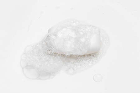 Soap bar and foam on white background, top view. Mockup for design
