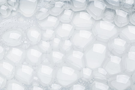 Background of soap foam and bubbles on a white background, macro photographyの写真素材
