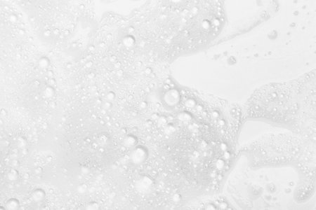 Abstract background white soapy foam texture. Shampoo foam with bubblesの写真素材