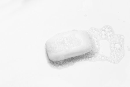 Soap bar and foam on white backgroundの写真素材
