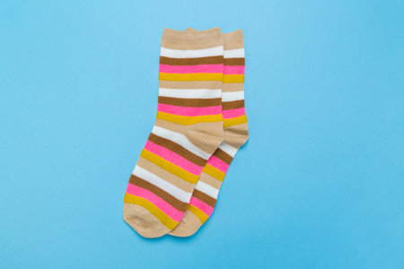 yellow new socks stacked on a blue background. top view.の写真素材