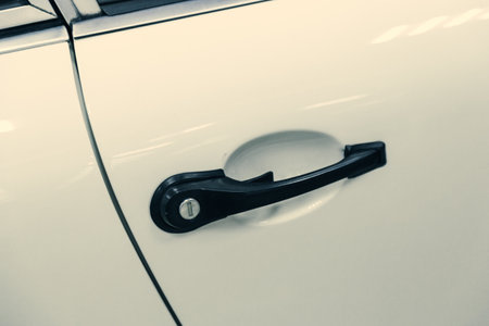 close-up of a door handle with a keyhole in a sports car