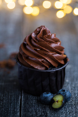 chocolate cupcake on dark wooden backgroundの写真素材