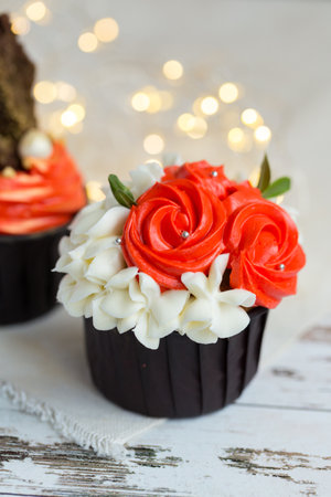 Cupcakes or muffins with chocolate cream and sweets. Cake celebration, delicious dessert, close-upの写真素材