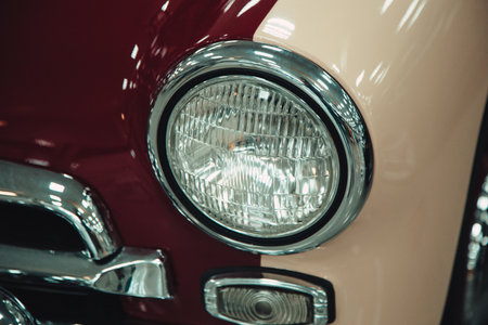 headlights of a retro car in red in the showroom. reconstruction