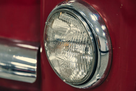 headlights of a retro car in red in the showroom. reconstruction