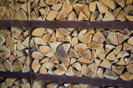 A lot of dry chopped firewood is stacked in the period of preparation for the furnace
