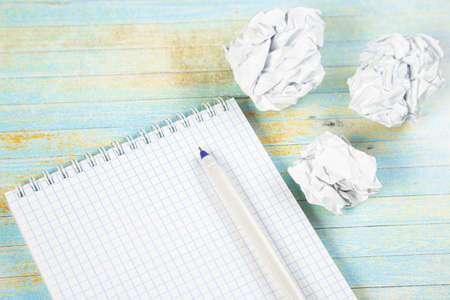 Paper balls and pen over blank white sheet - Creativity crisis conceptの写真素材