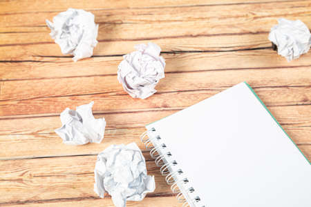 Paper balls and pen over blank white sheet - Creativity crisis conceptの写真素材
