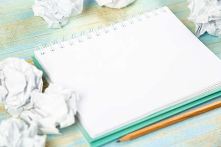 Paper balls and pen over blank white sheet - Creativity crisis concept