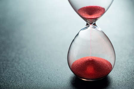 Sand glass, modern hourglass showing last second or last minute or time out. With copy space.