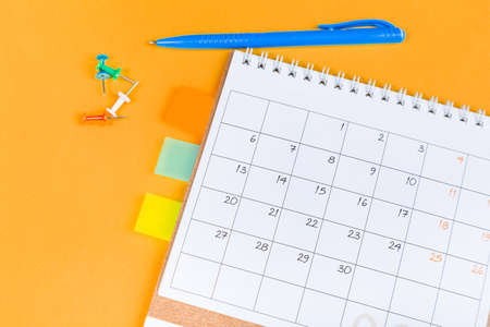 White blank 2021 calendar on solid orange background with copy space, business meeting schedule, travel planning or project milestone and reminder concept.の写真素材