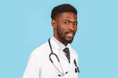 medicine, profession and healthcare concept. African American male doctor or scientist in white coat against blue backgroundの写真素材