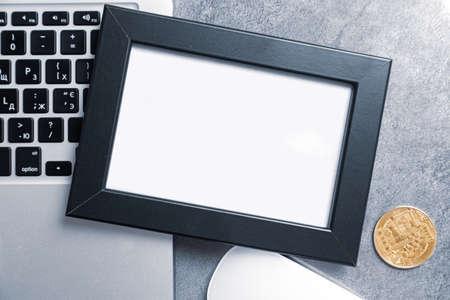 Nft (non fungible token) concept: big gold coin on a wooden table with a computer keyboard and dollar billsの写真素材