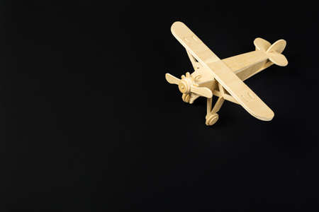 wooden model airplane with on a dark background. tourism and travel concept.の写真素材
