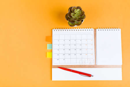 White blank 2021 calendar on solid orange background with copy space, business meeting schedule, travel planning or project milestone and reminder concept.の写真素材