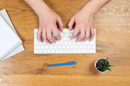 Businesswoman typing on computer keyboard at workplace Woman working in home office hand keyboardの写真素材
