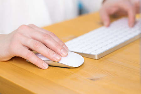 Close-up of young female hands pressing laptop buttons