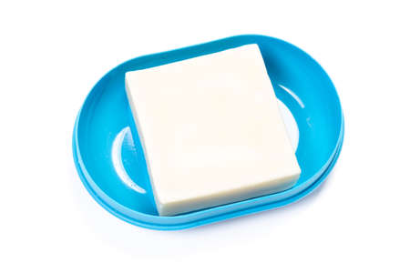 Soap in PLASTIC COLORED soap dish isolated on white backgroundの写真素材