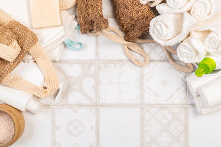 Bath accessories on a white background, top view, copy space. Daily body care concept, organic bath products. washcloth, towel, soapの写真素材
