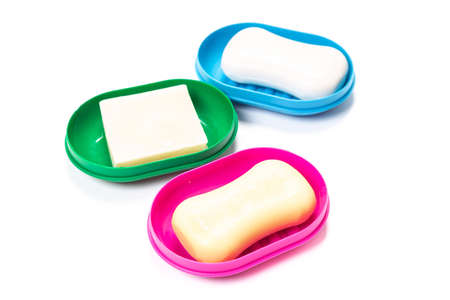 Soap in PLASTIC COLORED soap dish isolated on white background