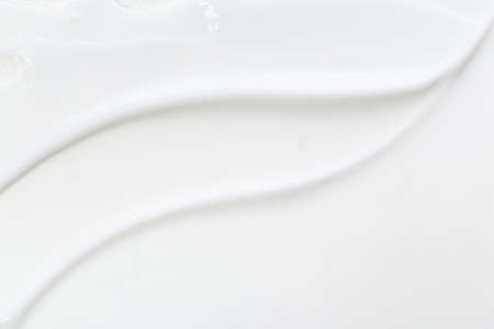 White face cream swirl swatch isolated. Body lotion drop. Cosmetic makeup product sample on white background.の写真素材